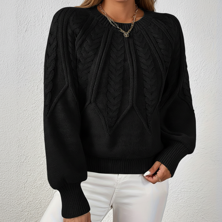 Model posing in a comfortable and chic women's cable knit jumper, perfect for cold weather