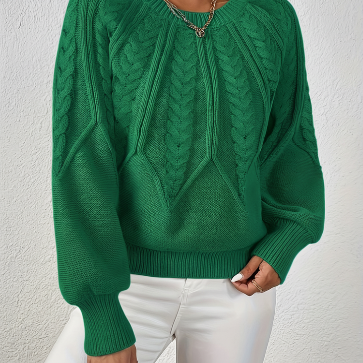 Knitted fabric of women's cozy cable knit sweater, highlighting quality and warmth of acrylic wool