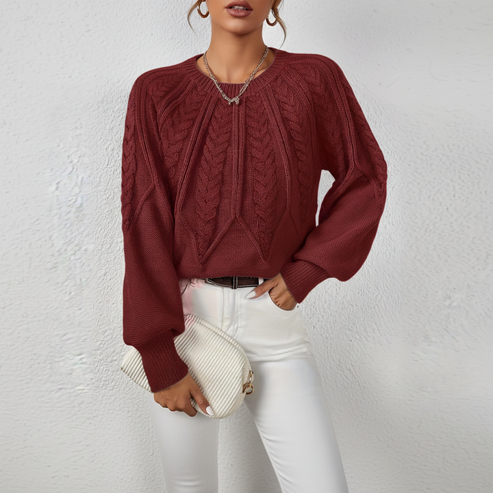 Close-up of hem and cable knit design on a women's cozy acrylic wool sweater, winter knitwear