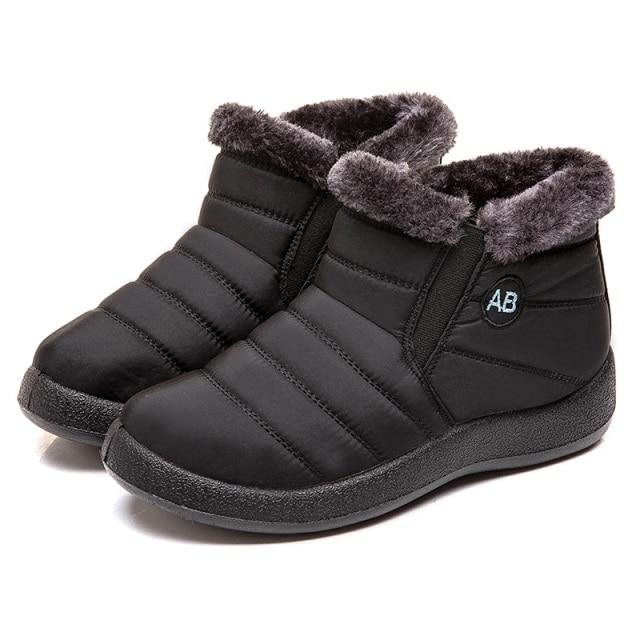 Women's durable winter boots on a snowy trail, perfect for cold weather travel & adventures.