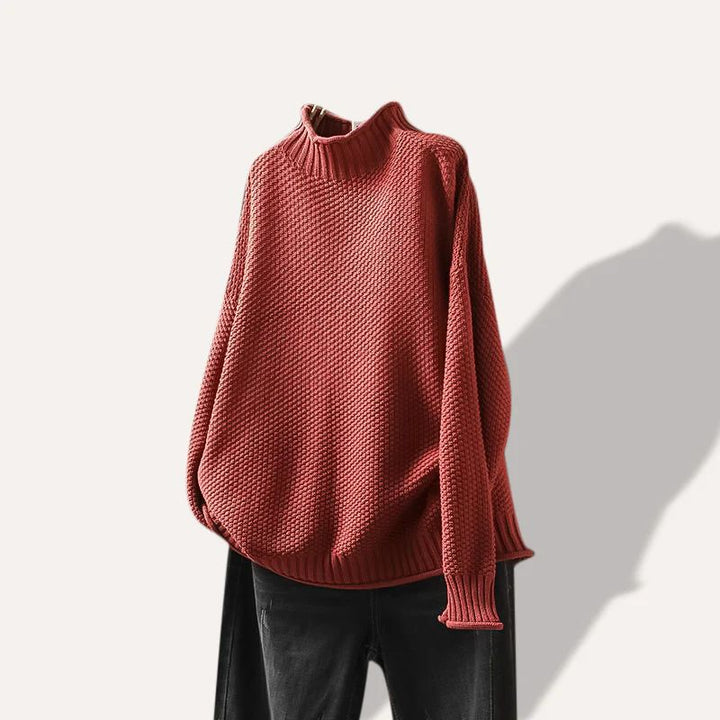 Woman wearing a stylish, cozy long-sleeve sweater. Perfect for comfortable everyday fall fashion.