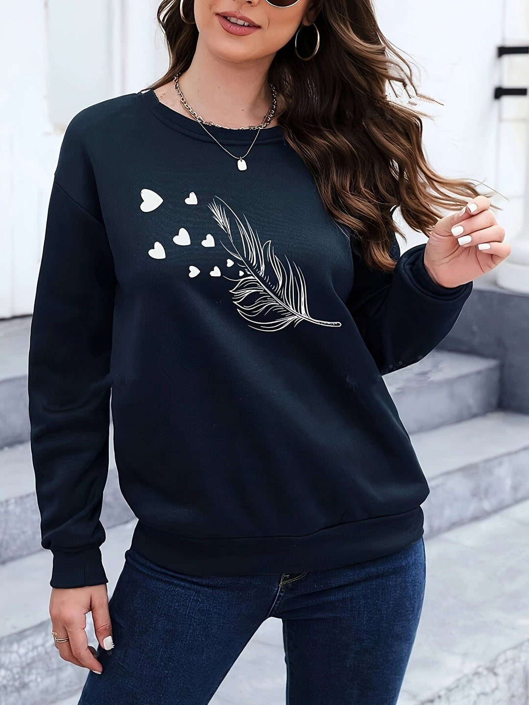 Marisa women's feather print long sleeve sweatshirt. Casual pullover for cozy autumn and winter style.