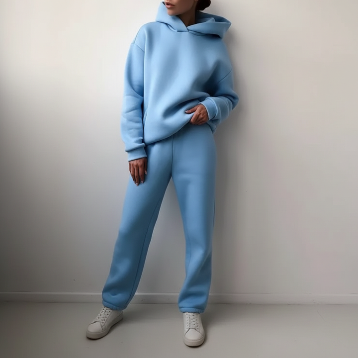Model lounging in the soft fleece hoodie and jogger set, emphasizing relaxation.