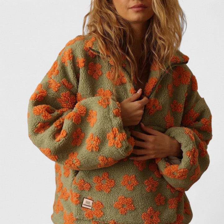 Oversized women's quarter-zip floral pullover. This stylish and warm sweater is perfect for casual outings.