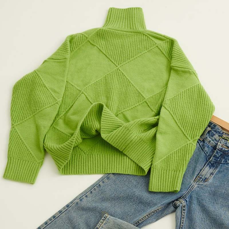 Detailed view of the knit pattern on a women's high-collar cozy sweater.
