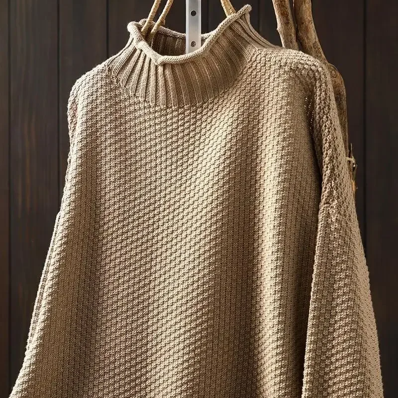 Chic women's pullover sweater with a cozy turtleneck and intricate honeycomb design.