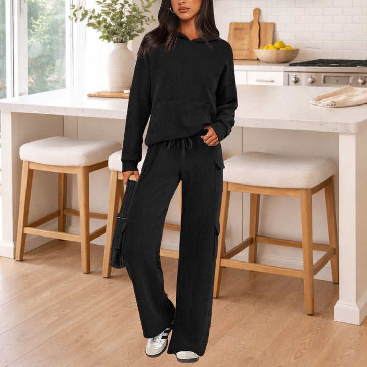 Modern women's knit lounge set. Stylish two-piece outfit with soft hoodie and wide-leg pants for athleisure comfort.