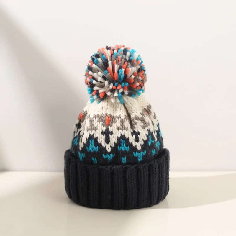 Stylish women's warm winter hat featuring a charming snowflake design & fun pom pom.