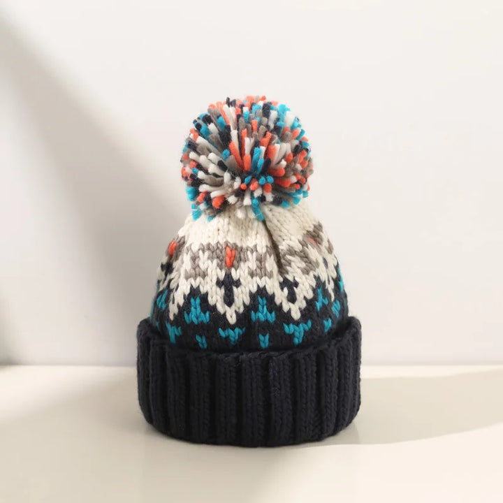 Stylish women's warm winter hat featuring a charming snowflake design & fun pom pom.