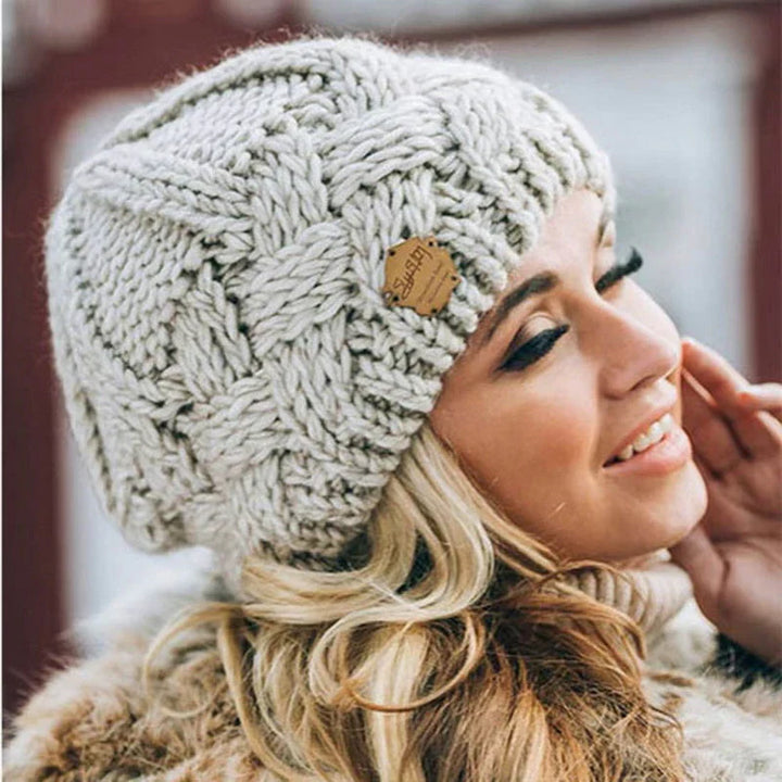 Women's cozy knitted winter hat in a warm, stylish beanie design for cold weather comfort.