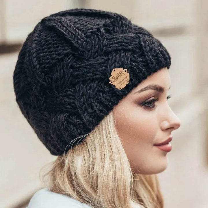 Soft, chunky knitted women's beanie hat, perfect for winter warmth and cozy cold weather style.
