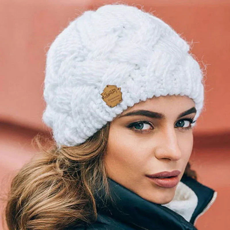 Fashionable women's knitted winter hat, a cozy and essential accessory for cold weather outfits.