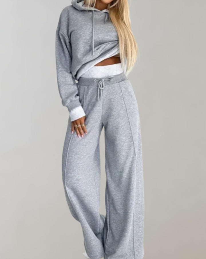 Fashionable women's oversized hoodie and flowing wide-leg pants loungewear set, a chic and cozy apparel choice.