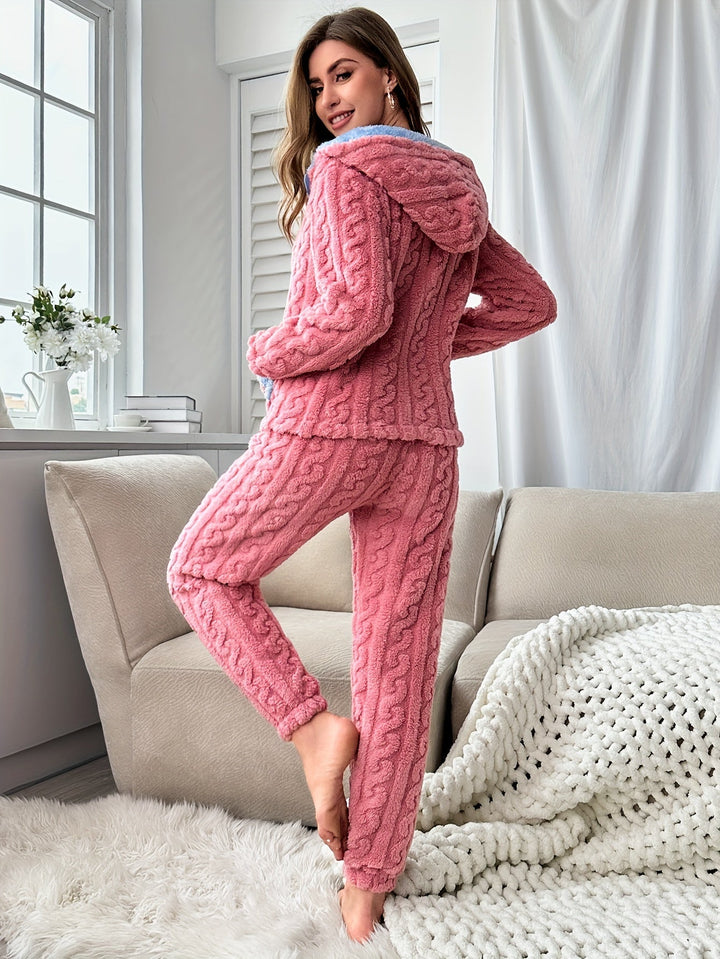 Soft pink fleece hooded pyjama set for women, featuring cozy trousers, ideal comfortable sleepwear.