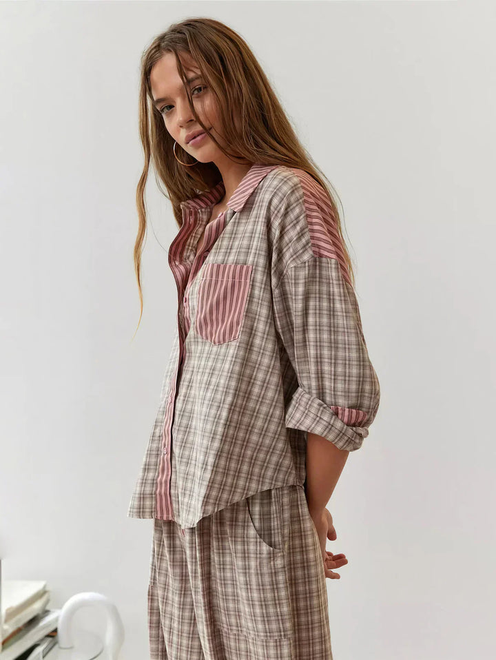 Pink & blue plaid women's pajama set. Button-up top & relaxed pants for stylish, comfortable sleepwear.