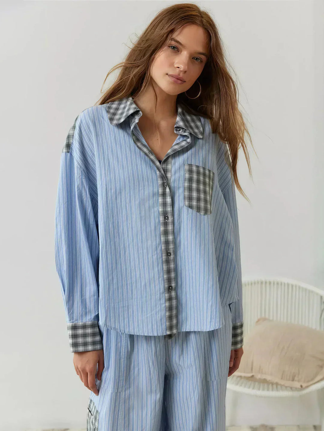 Two-piece women's plaid pajama set. Button-up long-sleeve shirt & elastic waist, relaxed fit pants for sleep.