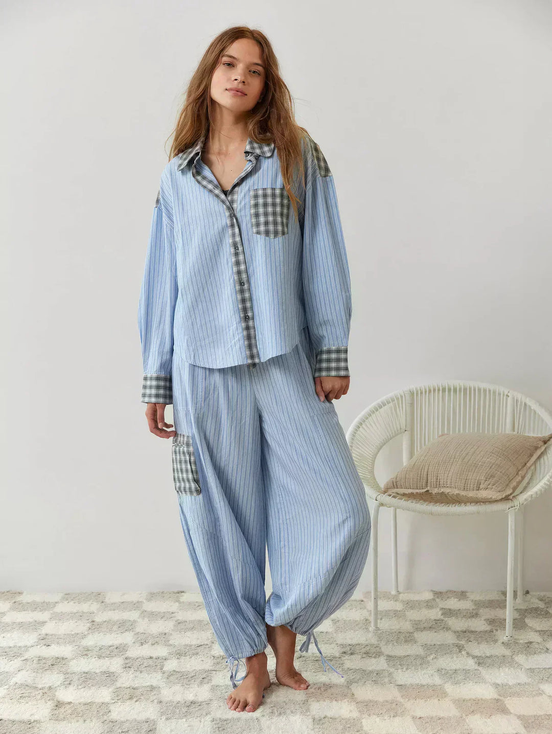 Blue plaid women's two-piece pajama set. Relaxed fit button-up top & matching pants for ultimate comfort.