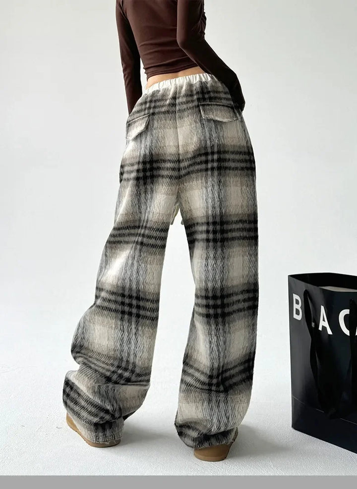 Stylish women's wide-leg plaid trousers, perfect for relaxed lounging or casual fashion.