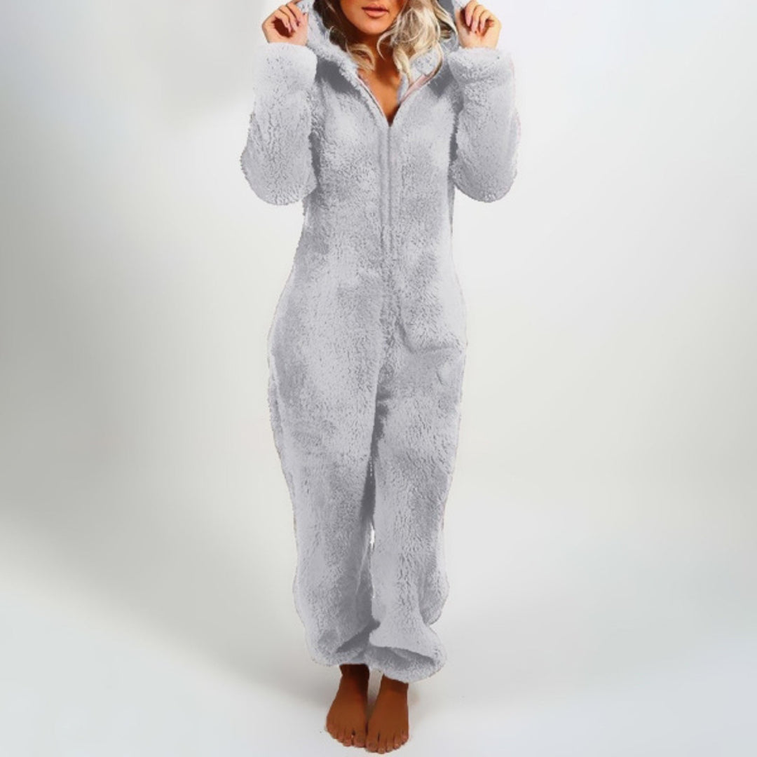 Soft women's plush hooded onesie, ideal for winter lounging. Features a comfy hood and full-body warmth.