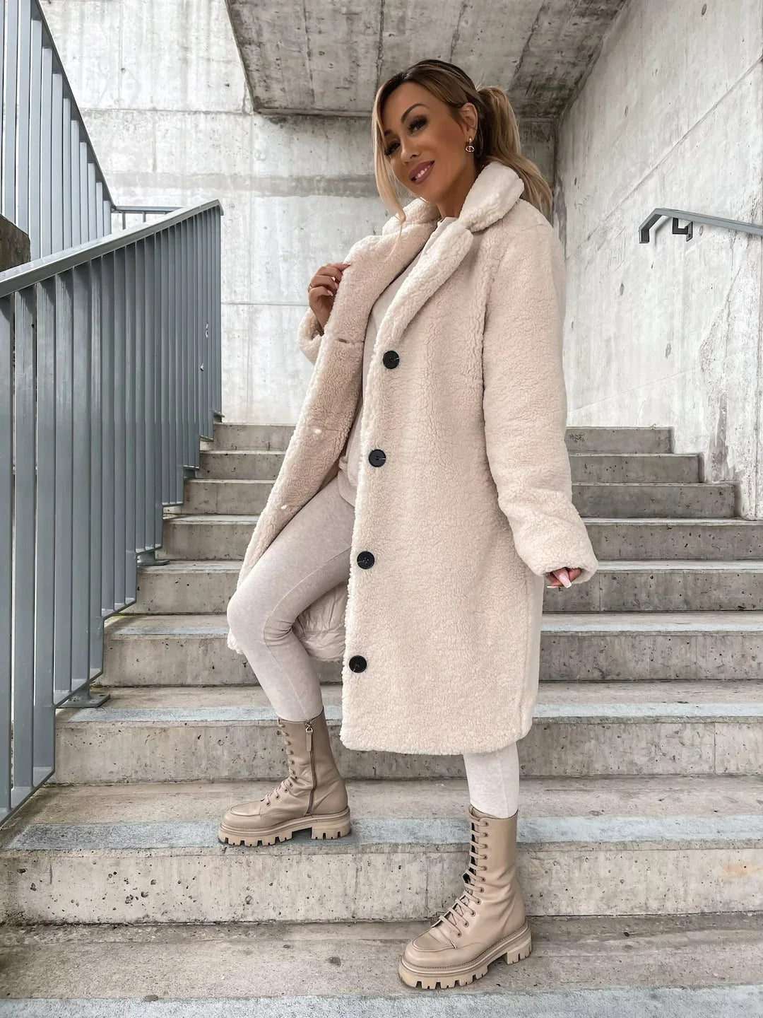 Plush longline teddy coat for women, a cozy and warm trench-style outerwear for cold seasons.