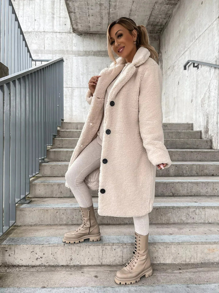 Plush longline teddy coat for women, a cozy and warm trench-style outerwear for cold seasons.