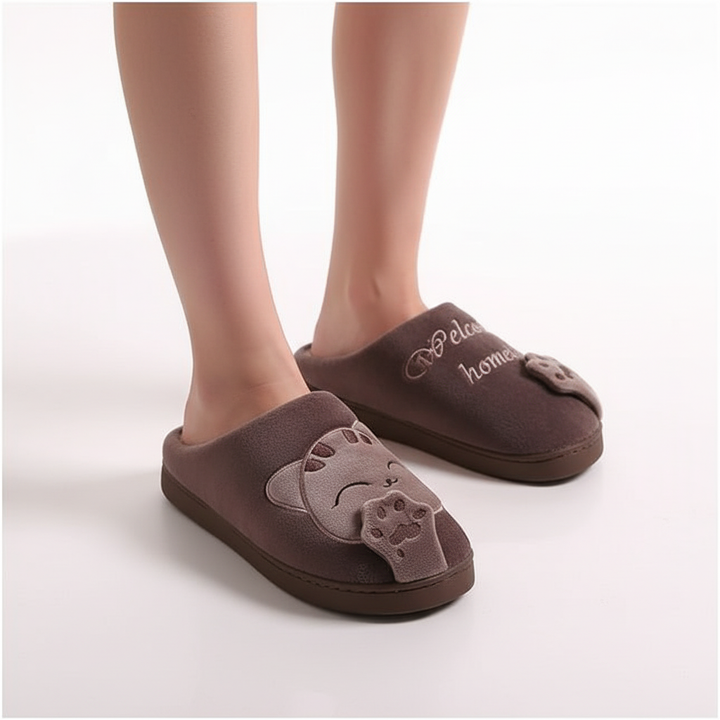 Close-up of fluffy women's slippers, tan, showing soft texture and warm lining, animal design