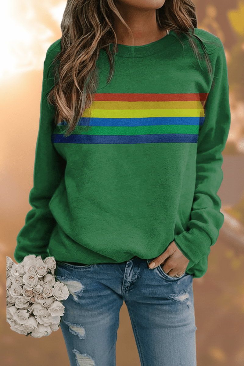 Close-up of a women's cozy rainbow striped sweatshirt, showcasing the vibrant colors and soft texture.