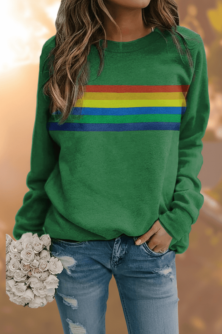 Close-up of a women's cozy rainbow striped sweatshirt, showcasing the vibrant colors and soft texture.