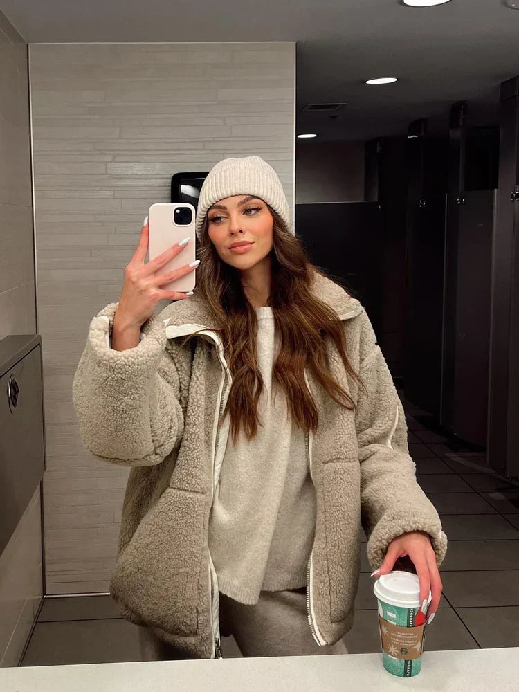 Woman confidently wearing a stylish & warm oversized teddy coat, ideal for fall/winter fashion.