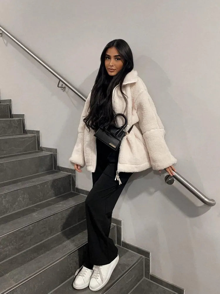 Warm women's teddy coat, a comfy and stylish plush jacket, essential outerwear for cold weather.