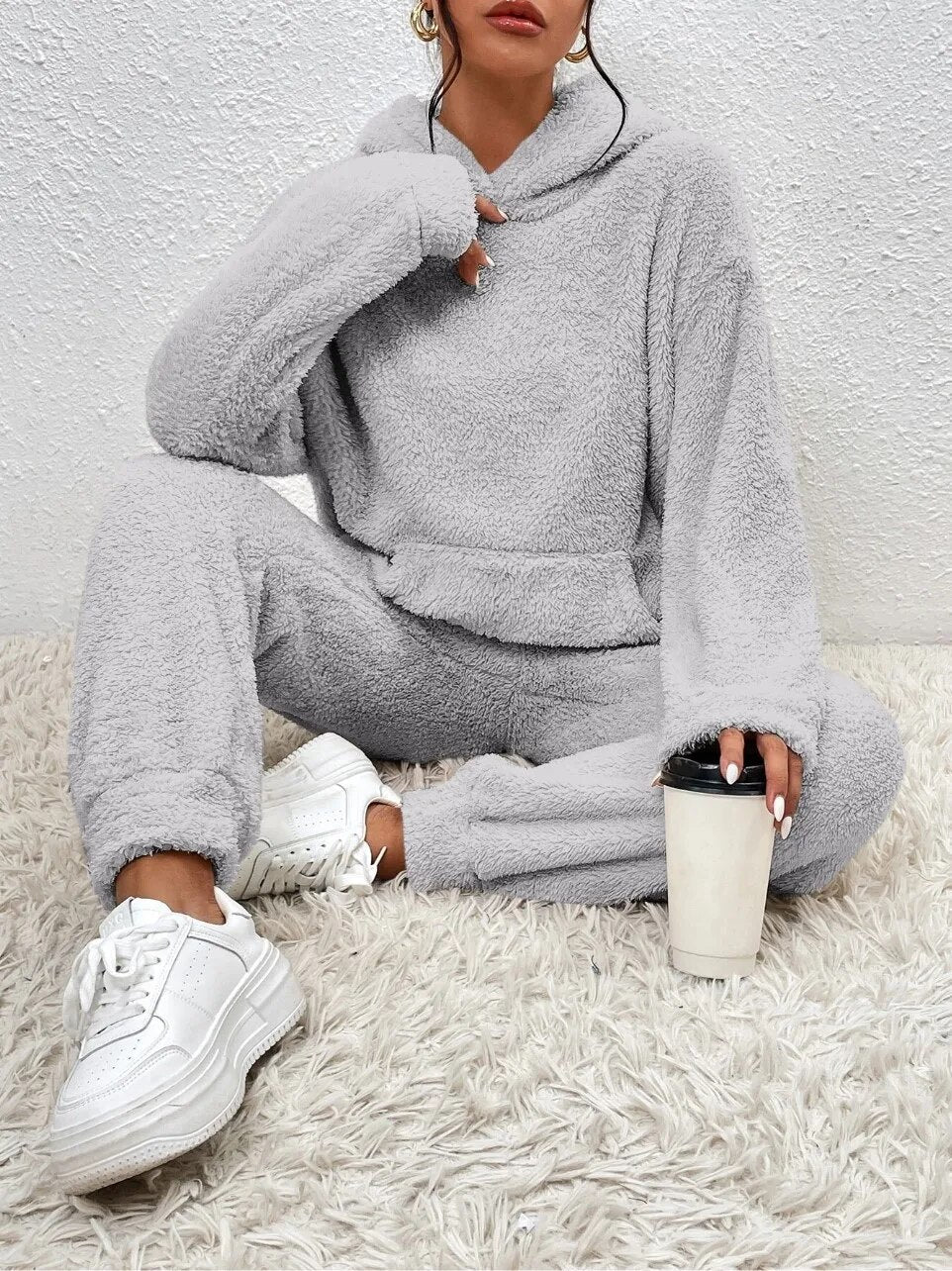 Women's luxurious hooded teddy loungewear. Soft fabric, perfect two-piece for relaxation & comfort.