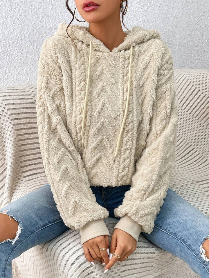 Women's cozy textured pullover hoodie in a relaxed style, perfect for soft, comfortable everyday wear.