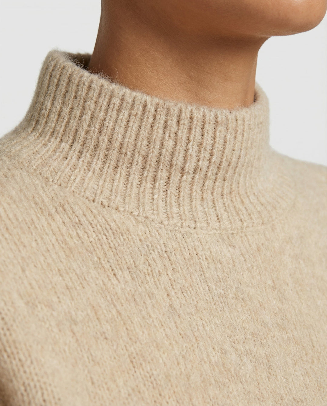 Cozy women's textured turtleneck sweater, a stylish and warm pullover for winter fashion.