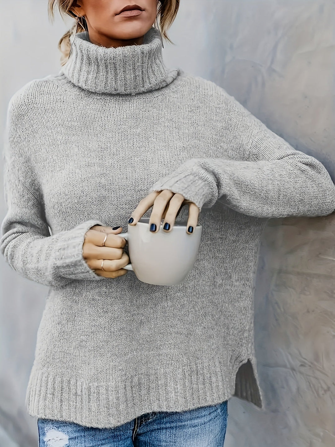 Layer up with this women's relaxed fit turtleneck sweater, featuring a side split hem & soft knit.