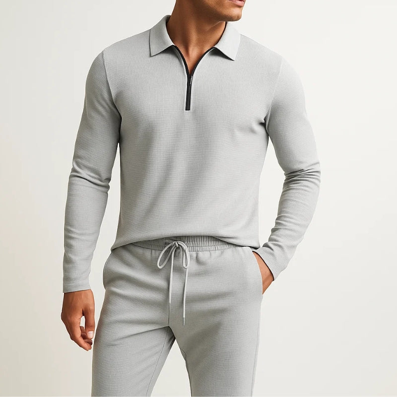 Comfortable women's two-piece waffle knit sweatsuit. Cozy jogger set with zip-front top for relaxing.
