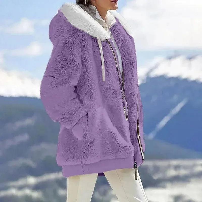 Close-up of the cozy fabric on a women's winter jacket with hood and durable zipper closure.