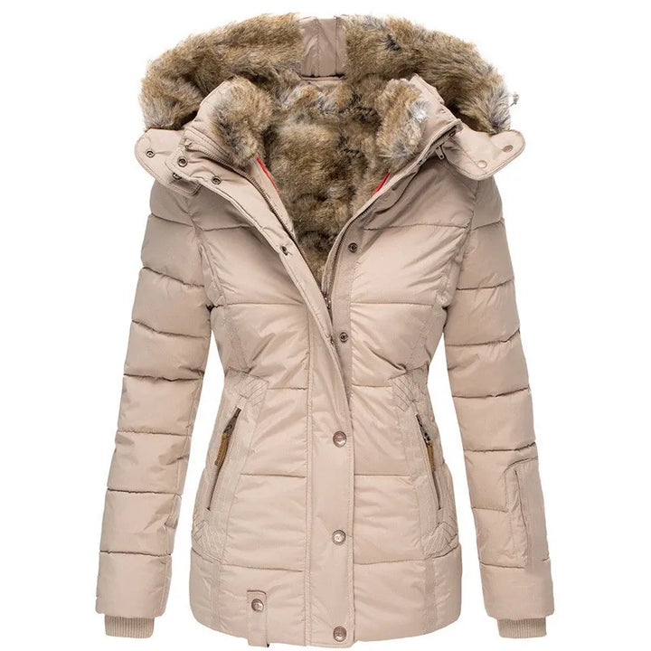 Woman wears a cozy winter jacket with plush hood trim. Stylish protection and warmth for cold weather apparel.
