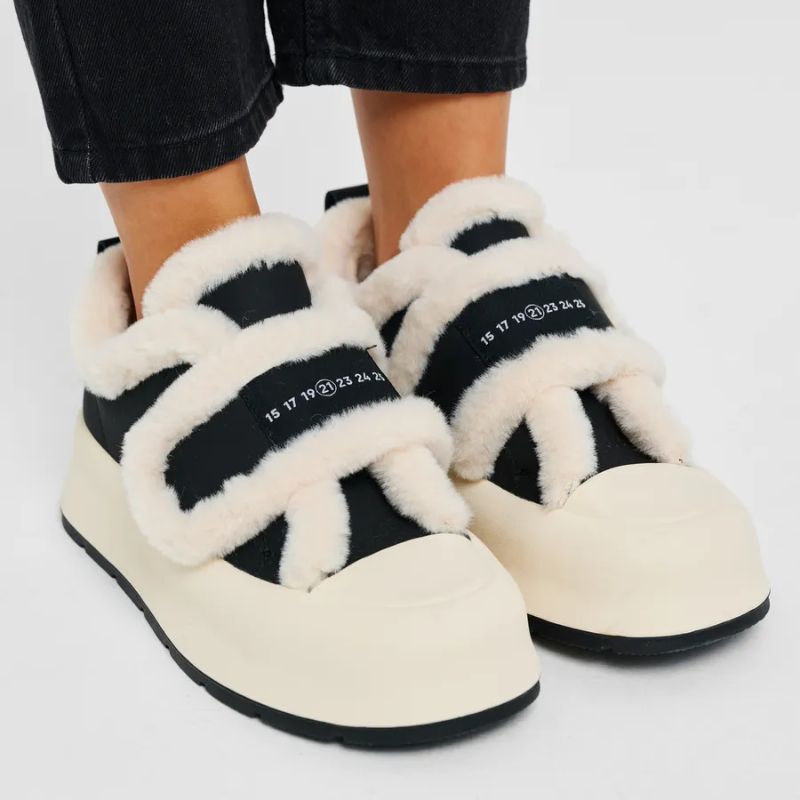 Women's cozy winter slip-on shoes with warm lining & stylish strap detail for comfortable daily wear.
