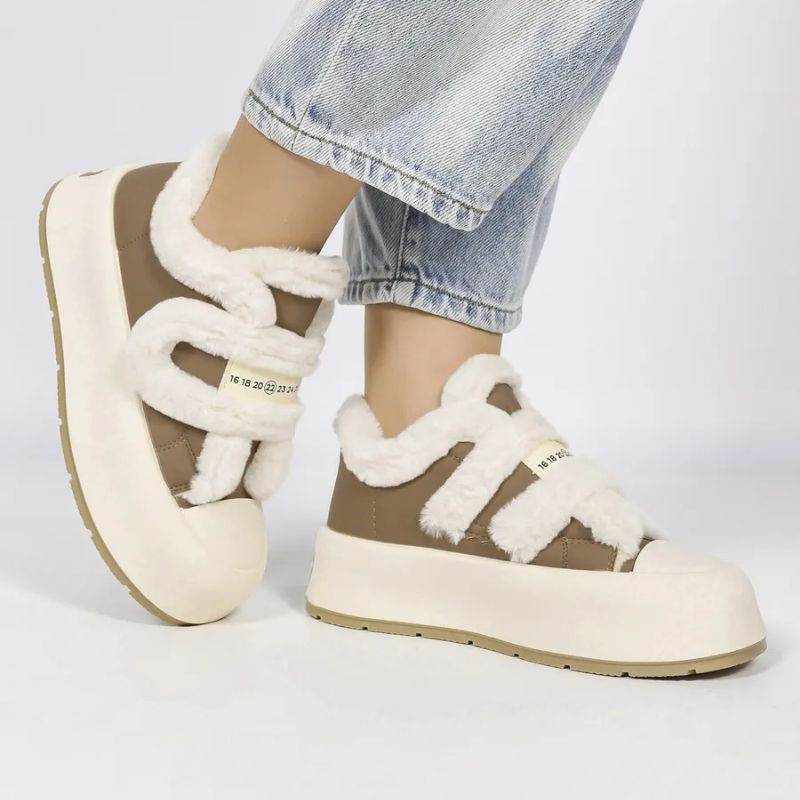 Modern women's cozy winter slip-on shoes. Warm, comfortable footwear with stylish strap for casual daily wear.