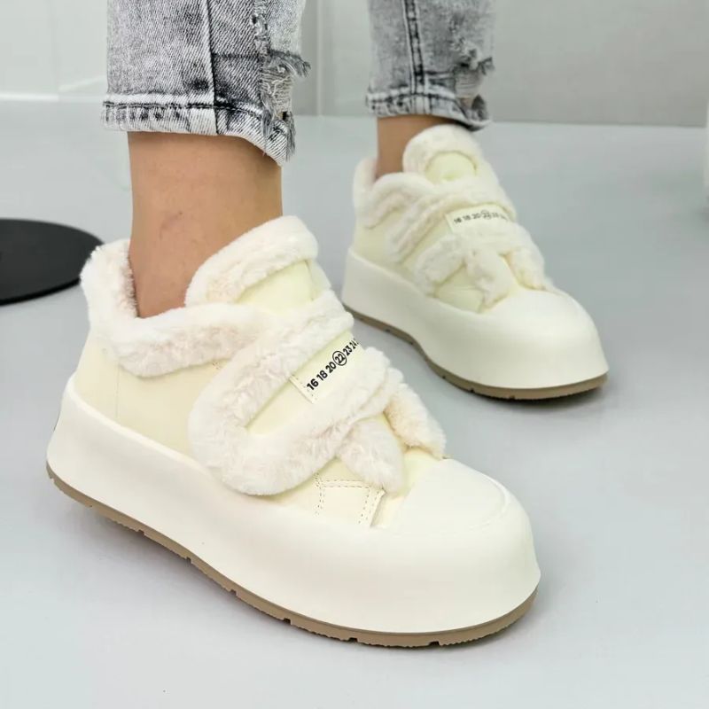 Women's cozy winter slip-on shoes with stylish strap detail. Warm, comfortable footwear for daily casual wear.
