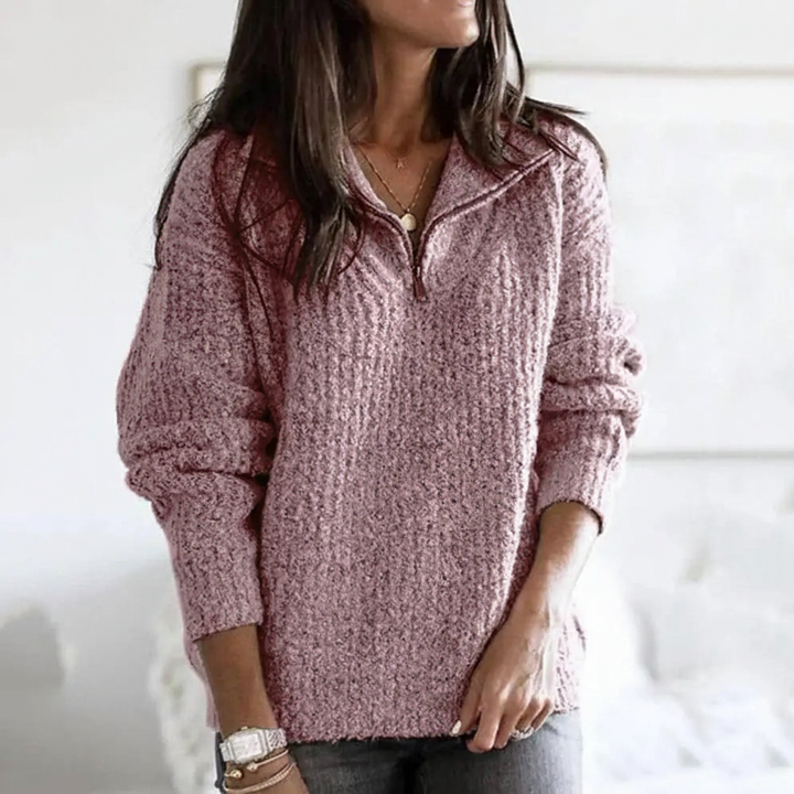 Detail of the half-zip closure on a women's knitted autumn sweater, emphasizing modern design