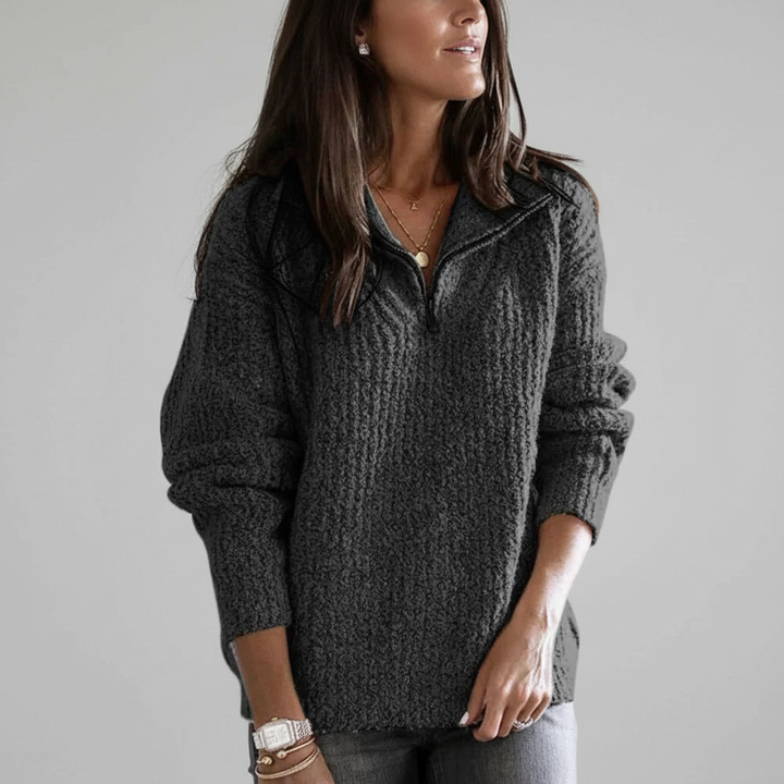 Studio shot of a women's knitted half-zip autumn sweater, highlighting its soft fabric and loose fit
