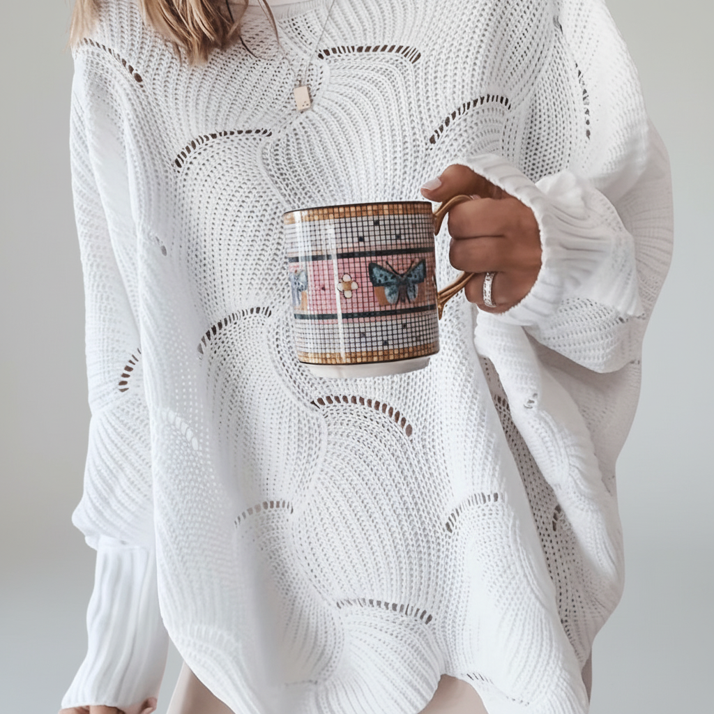 Close-up of women's ribbed knit asymmetrical top in cream, cozy and stylish