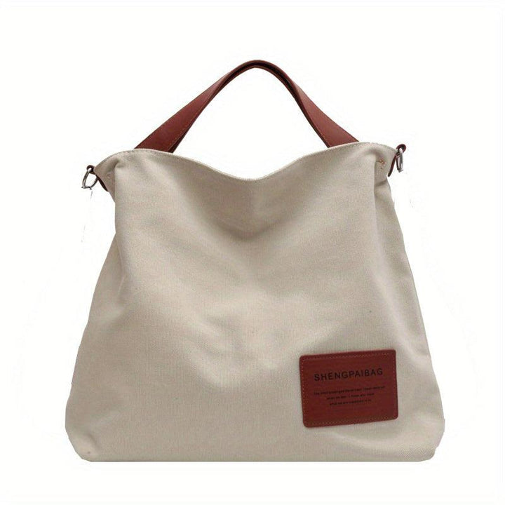 Women's cream white canvas shoulder bag, versatile for everyday style & cross-body wear.