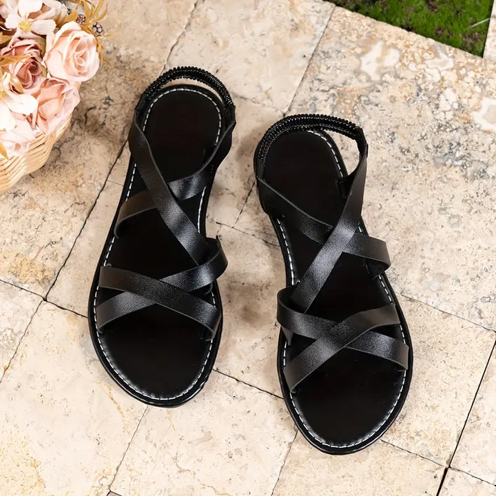 Front view of women's comfortable criss-cross Roman flat sandals, a summer footwear essential.