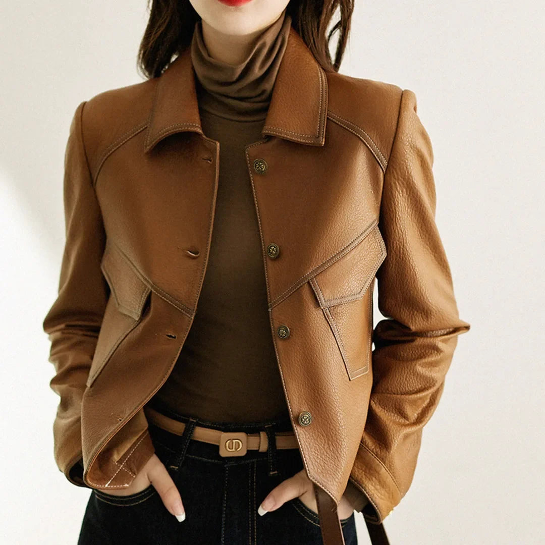 Women's cropped faux leather jacket with lapel collar. Chic modern fall fashion outerwear.