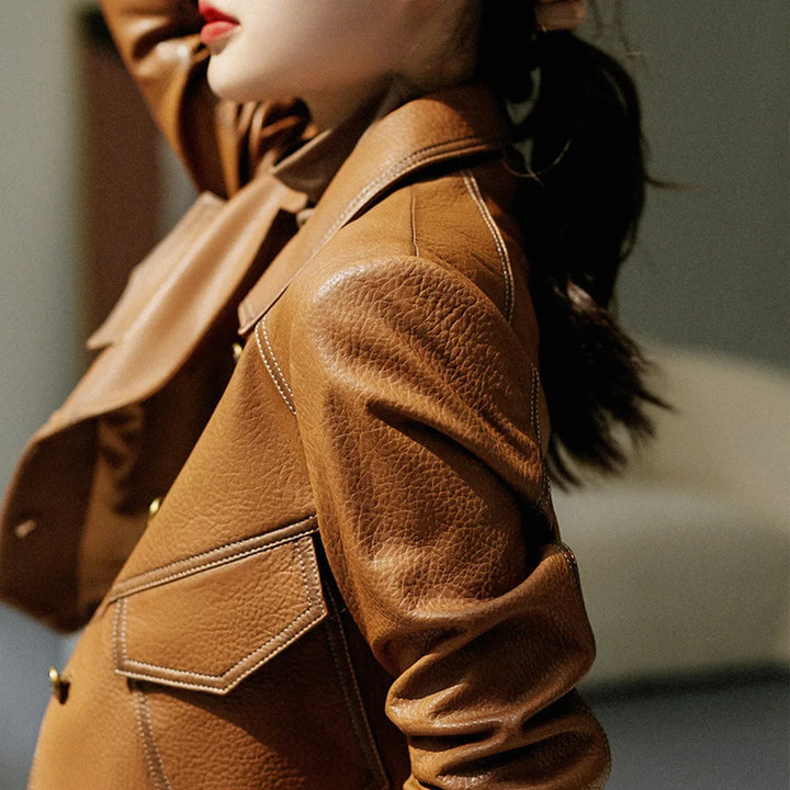 Fashionable women's cropped faux leather jacket. Modern statement outerwear for chic style.