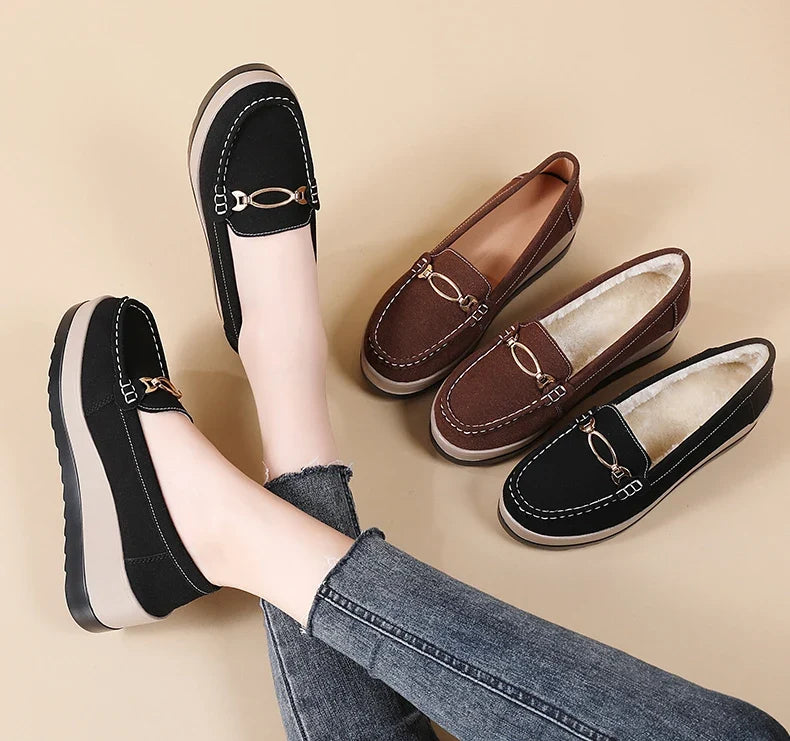 Side profile of women's platform lift loafers, highlighting the cushioned sole & elegant silhouette.