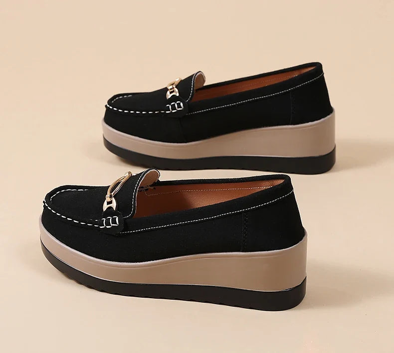 Woman wearing stylish platform loafers. Cushioned slip-on shoes for a chic, comfortable look.