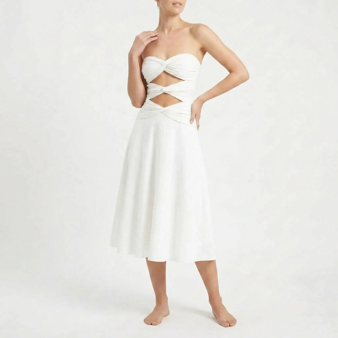 Women's two-piece resort outfit: cutout bandeau swimsuit & elegant long skirt.